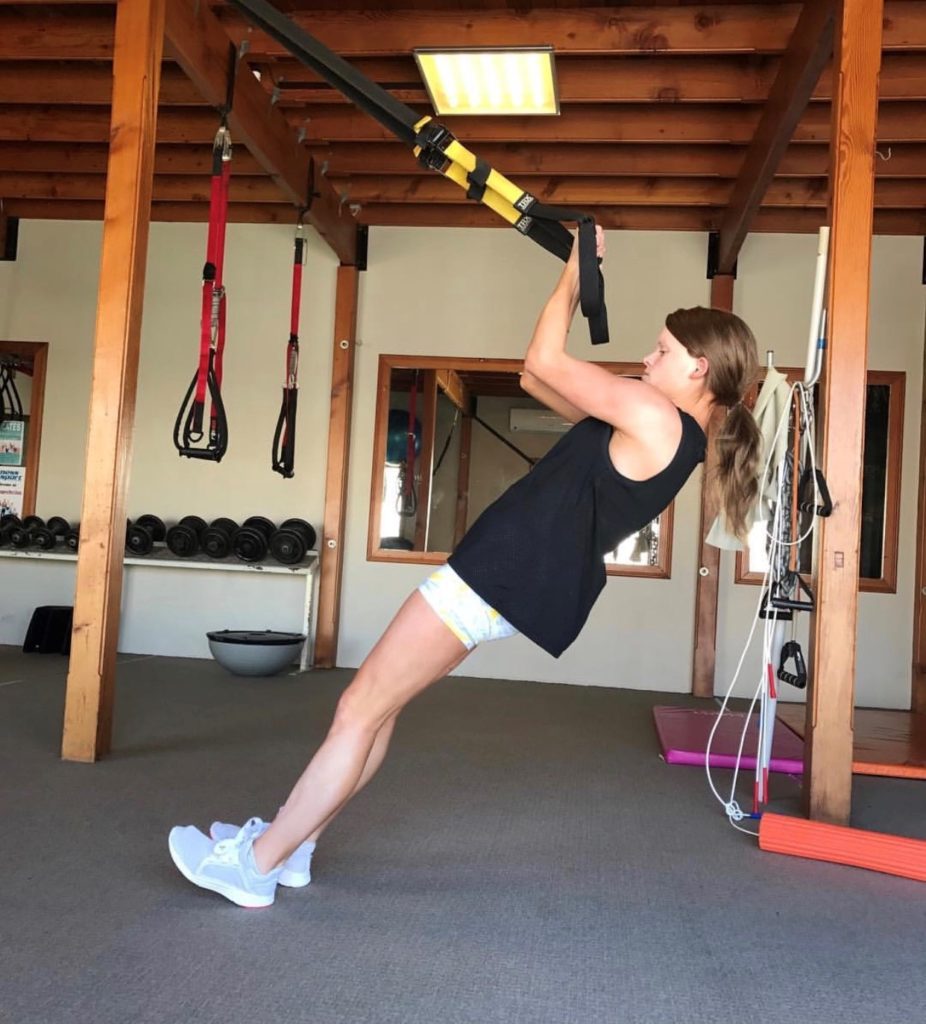 Tash, exercising in an indoor gym.
