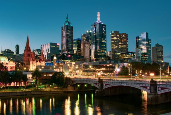 The Princes Bridge at night, with the city of Melbourne illuminated in the background.