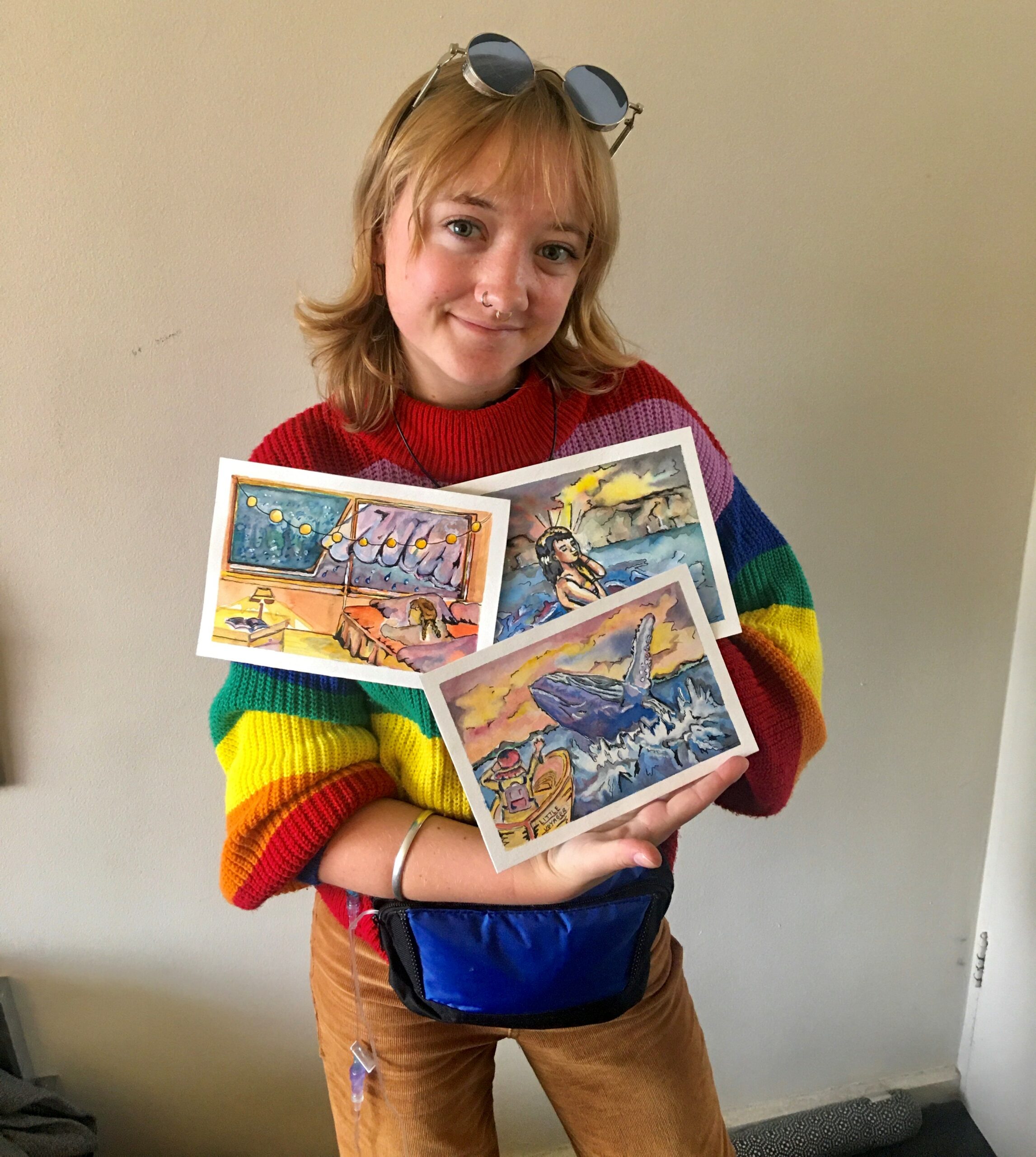 Lucy Paterson, who was diagnosed with CF at four months, presenting three of her artworks to the camera..