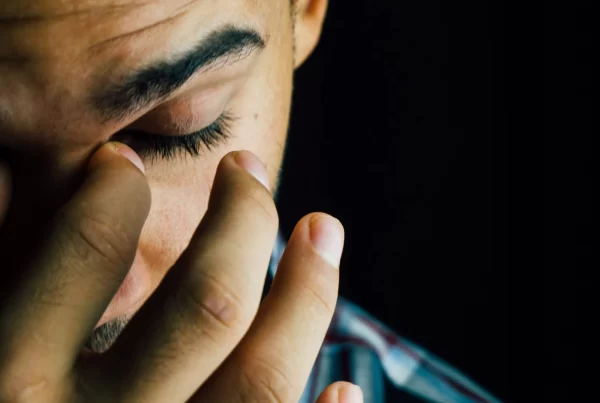 Sinus disease and CF | Man facing down pinching his nose