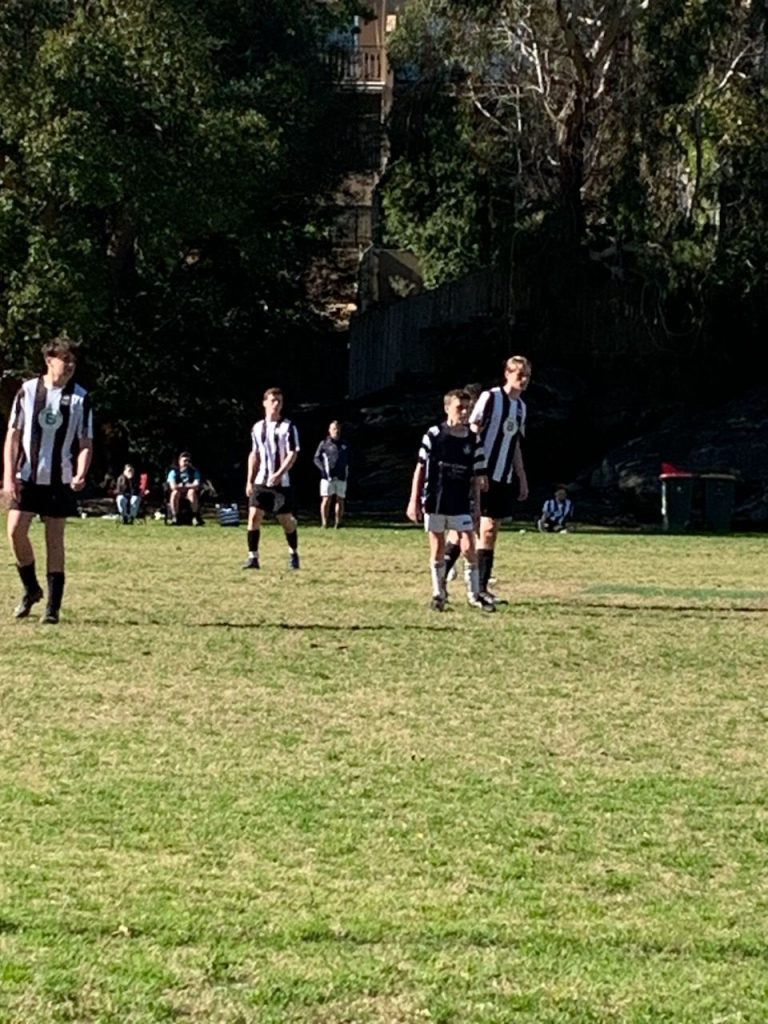 Men playing football on the field | CF and body image