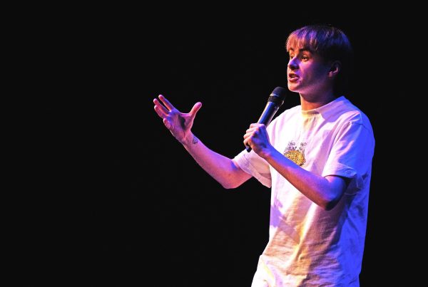 Man standing with a microphone | CF and work